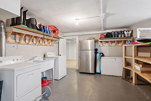 washroom featuring washer and dryer and a textured ceiling