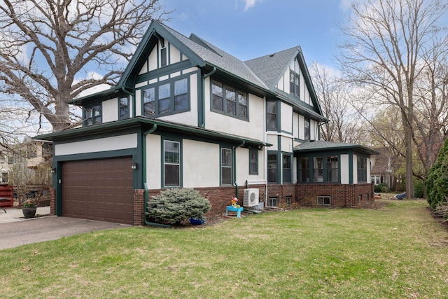 view of front of home with a front lawn, aphalt driveway, stucco siding, brick siding, and an attached garage