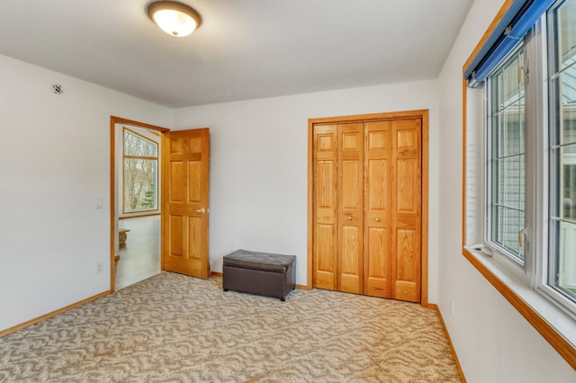 interior space with carpet floors and baseboards