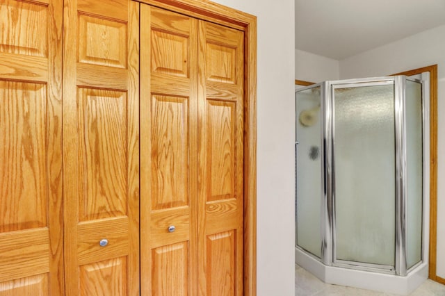 full bath featuring tile patterned floors and a stall shower