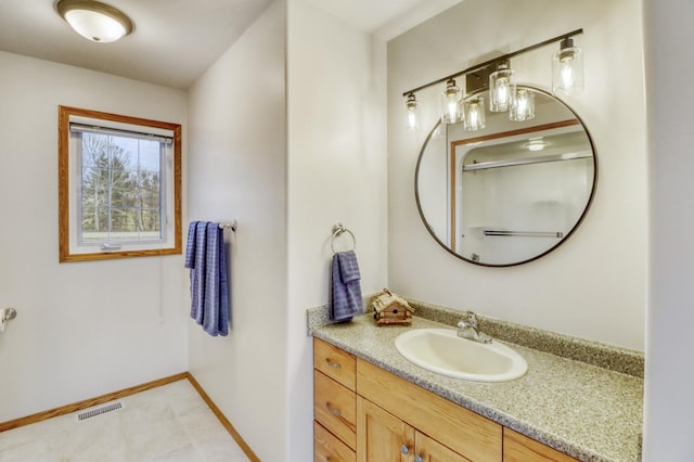 bathroom with visible vents, baseboards, and vanity