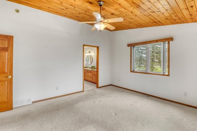 empty room featuring visible vents, wood ceiling, ceiling fan, and light colored carpet