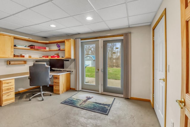 office area with built in study area, recessed lighting, baseboards, and a paneled ceiling