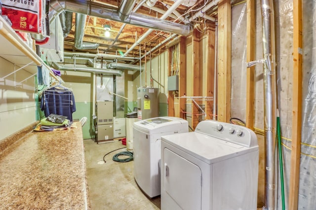 clothes washing area featuring water heater, heating unit, laundry area, and washing machine and clothes dryer
