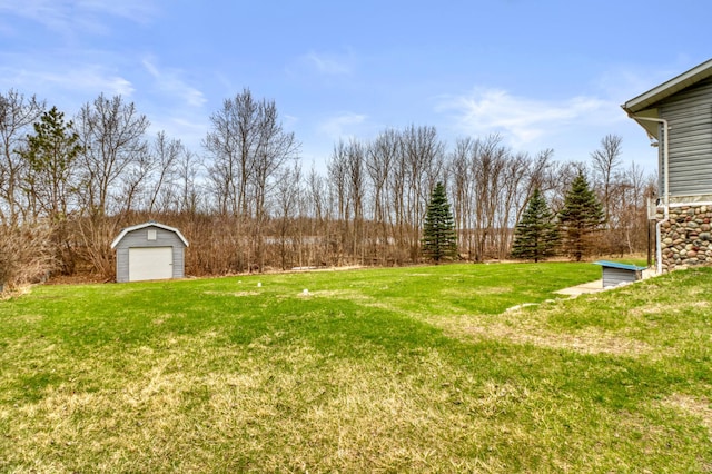 view of yard with a storage shed, an outbuilding, and a garage