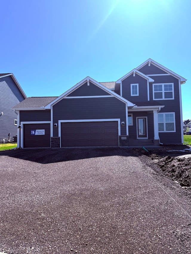 10124 Arrowwood Trl, Woodbury, MN 55129 - view of front of house featuring an attached garage and asphalt driveway