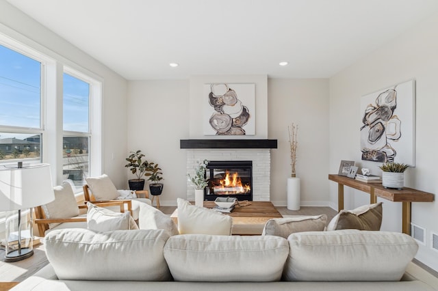 10124 Arrowwood Trl, Woodbury, MN 55129 - living room featuring a glass covered fireplace, baseboards, and recessed lighting