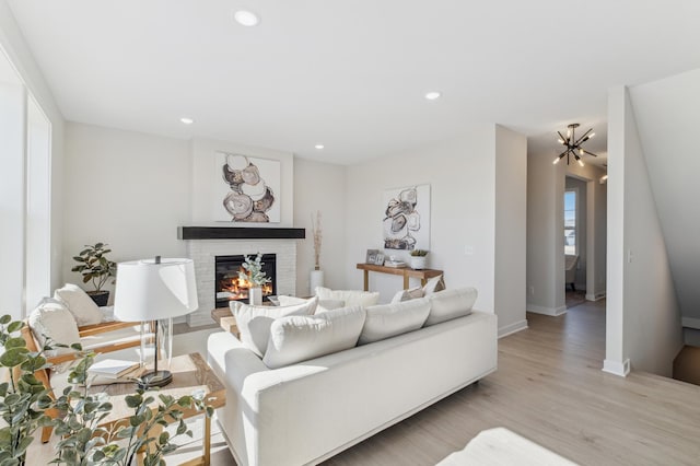 10124 Arrowwood Trl, Woodbury, MN 55129 - living room with a brick fireplace, light wood-type flooring, recessed lighting, and baseboards