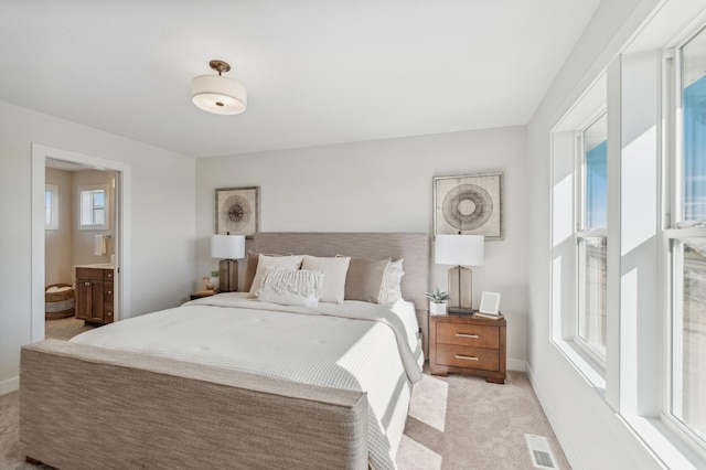 10124 Arrowwood Trl, Woodbury, MN 55129 - bedroom featuring light colored carpet, baseboards, and ensuite bathroom