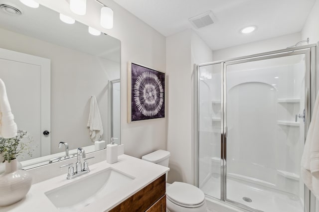 10124 Arrowwood Trl, Woodbury, MN 55129 - bathroom featuring a stall shower, vanity, and toilet