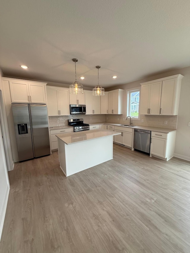 10124 Arrowwood Trl, Woodbury, MN 55129 - kitchen featuring stainless steel appliances, a sink, light countertops, backsplash, and recessed lighting