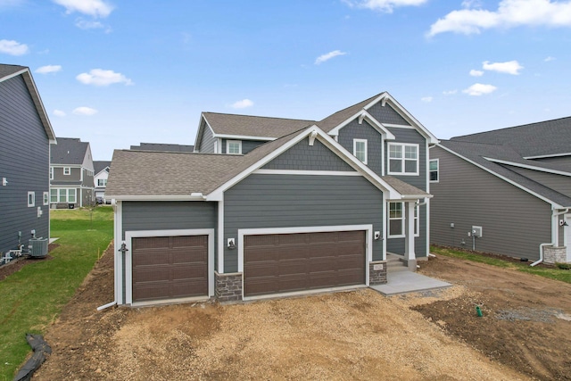 10124 Arrowwood Trl, Woodbury, MN 55129 - craftsman house featuring central AC unit, dirt driveway, a garage, and a front lawn