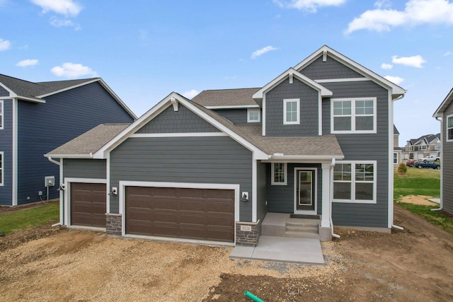 10124 Arrowwood Trl, Woodbury, MN 55129 - craftsman house featuring dirt driveway, an attached garage, a shingled roof, and stone siding