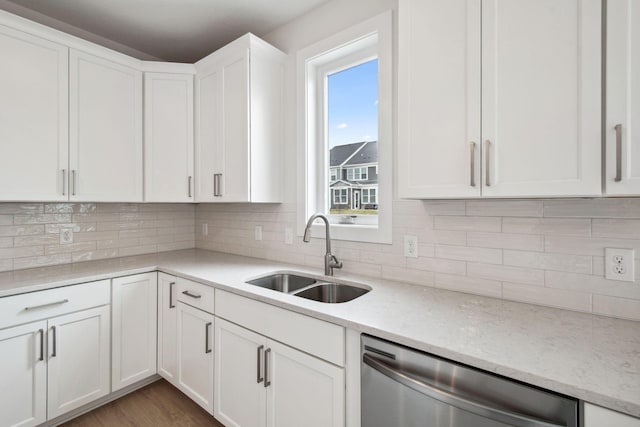 10124 Arrowwood Trl, Woodbury, MN 55129 - kitchen featuring dishwasher, a sink, white cabinets, tasteful backsplash, and light stone countertops