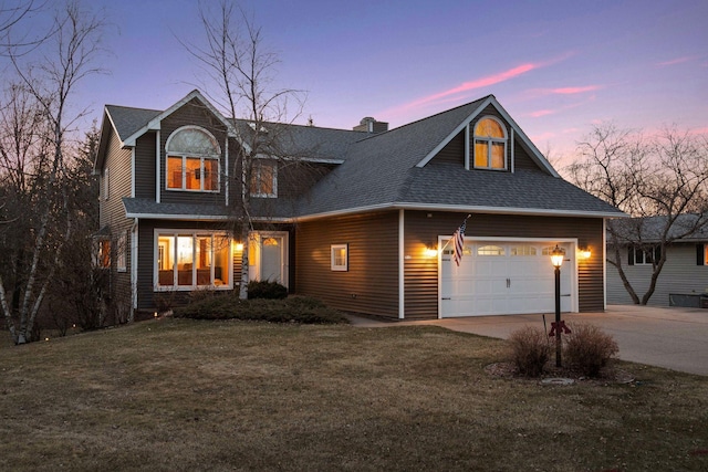 view of front of house featuring concrete driveway, roof with shingles, an attached garage, and a lawn