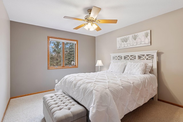 carpeted bedroom featuring baseboards and a ceiling fan