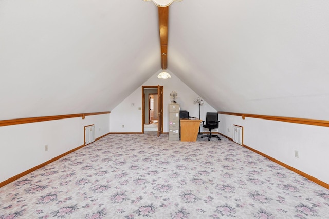 unfurnished office with light colored carpet, baseboards, and vaulted ceiling