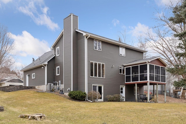 515 Greaton Rd, New Richmond, WI 54017 - rear view of property with a sunroom, a chimney, a lawn, and a patio