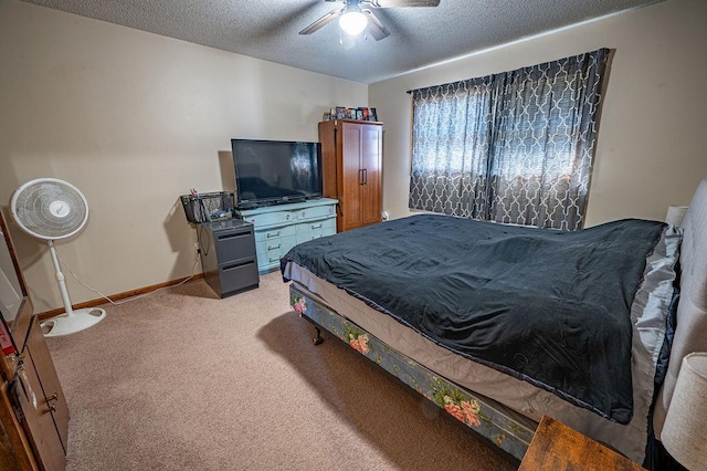 bedroom featuring light colored carpet, a ceiling fan, baseboards, and a textured ceiling
