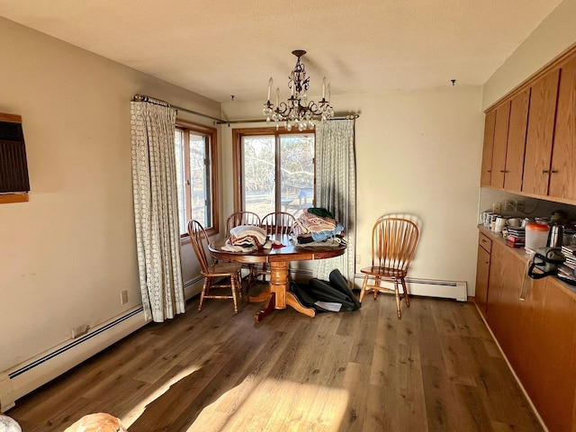 dining area with wood finished floors, baseboard heating, and a notable chandelier