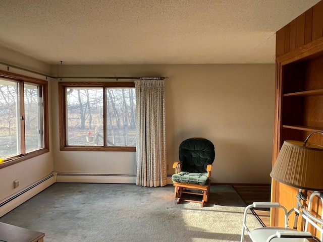 unfurnished room featuring a baseboard heating unit, carpet floors, and a textured ceiling