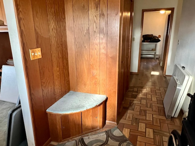 hallway featuring radiator and baseboards
