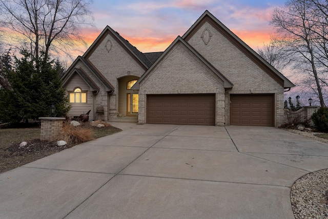 13162 Glenhaven Ave, Apple Valley, MN 55124 - french country inspired facade with brick siding, concrete driveway, and an attached garage