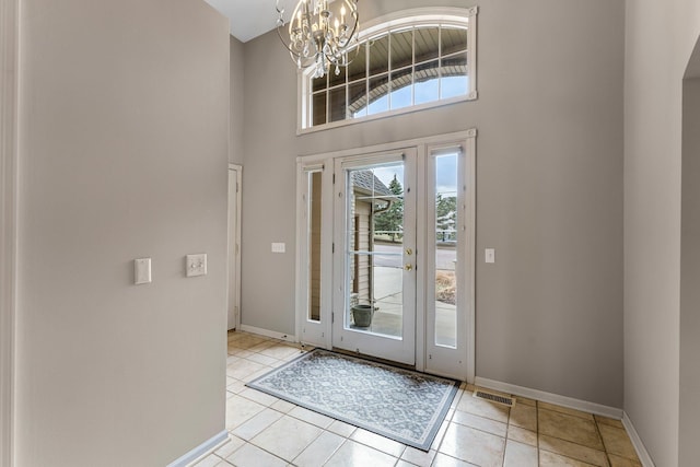13162 Glenhaven Ave, Apple Valley, MN 55124 - foyer entrance featuring a chandelier, baseboards, tile patterned flooring, and a high ceiling