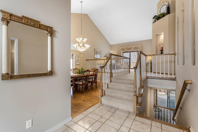 13162 Glenhaven Ave, Apple Valley, MN 55124 - staircase with high vaulted ceiling, a chandelier, plenty of natural light, tile patterned flooring, and baseboards