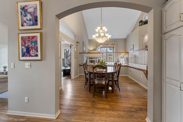 13162 Glenhaven Ave, Apple Valley, MN 55124 - dining area featuring arched walkways, wood finished floors, baseboards, a chandelier, and vaulted ceiling