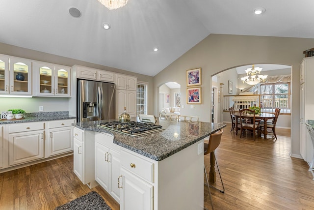 13162 Glenhaven Ave, Apple Valley, MN 55124 - kitchen featuring stainless steel appliances, arched walkways, a chandelier, vaulted ceiling, and a kitchen breakfast bar