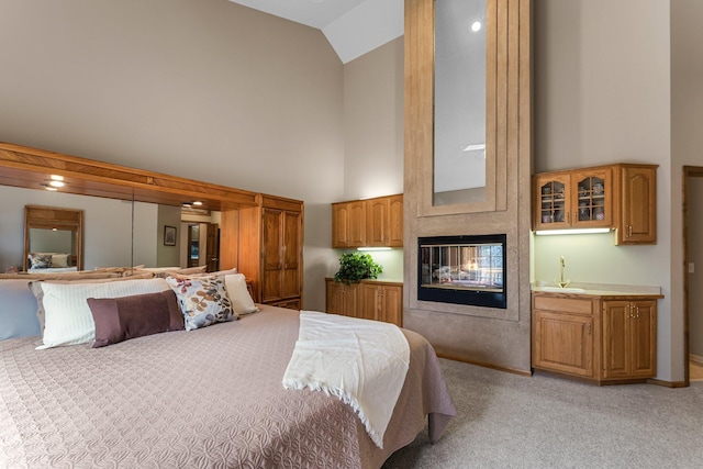 13162 Glenhaven Ave, Apple Valley, MN 55124 - bedroom with high vaulted ceiling, light carpet, and a multi sided fireplace