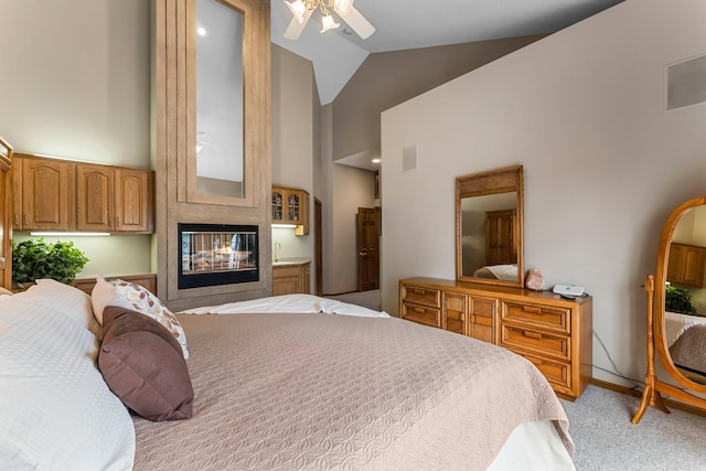 13162 Glenhaven Ave, Apple Valley, MN 55124 - bedroom featuring high vaulted ceiling, light colored carpet, baseboards, and a multi sided fireplace