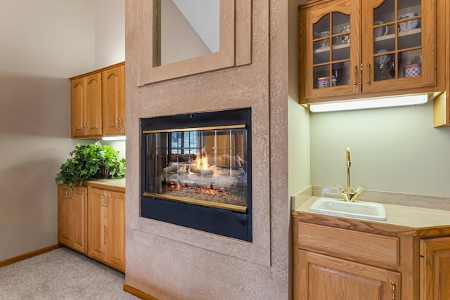 13162 Glenhaven Ave, Apple Valley, MN 55124 - bar with a sink, light carpet, a multi sided fireplace, and baseboards