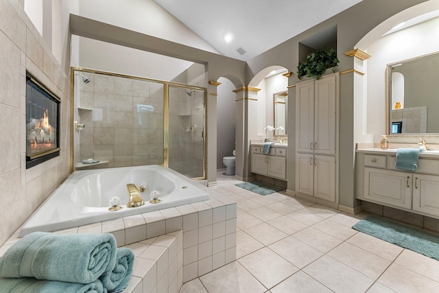 13162 Glenhaven Ave, Apple Valley, MN 55124 - bathroom featuring toilet, a whirlpool tub, a shower stall, vaulted ceiling, and vanity