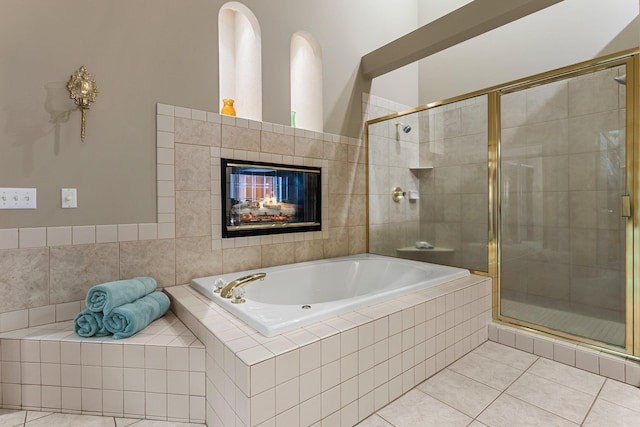 13162 Glenhaven Ave, Apple Valley, MN 55124 - full bathroom featuring tile patterned flooring, a garden tub, a stall shower, and a tiled fireplace