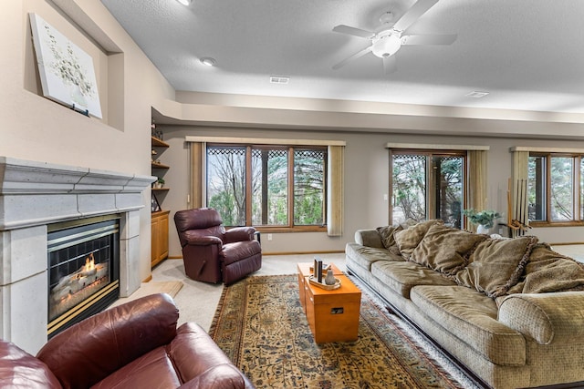 13162 Glenhaven Ave, Apple Valley, MN 55124 - living room with a glass covered fireplace, light colored carpet, and a ceiling fan
