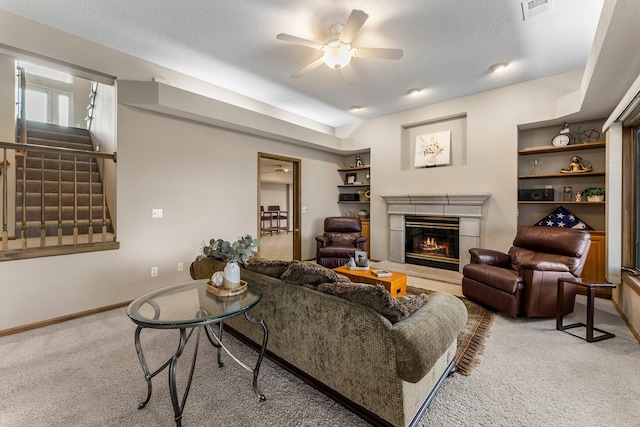 13162 Glenhaven Ave, Apple Valley, MN 55124 - carpeted living room featuring a ceiling fan, a fireplace, stairway, and baseboards