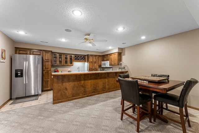 13162 Glenhaven Ave, Apple Valley, MN 55124 - dining space featuring ceiling fan, light colored carpet, bar with sink, recessed lighting, and a textured ceiling