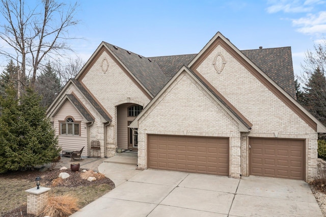 13162 Glenhaven Ave, Apple Valley, MN 55124 - french country inspired facade with concrete driveway, a garage, brick siding, and a shingled roof