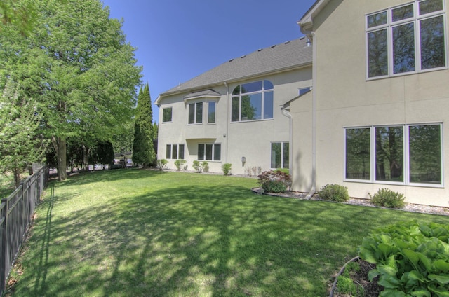rear view of property featuring stucco siding