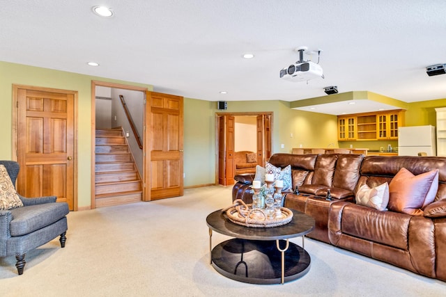 living room featuring light carpet, stairs, and recessed lighting