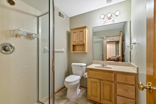 full bath featuring a stall shower, toilet, vanity, tile patterned floors, and a textured ceiling