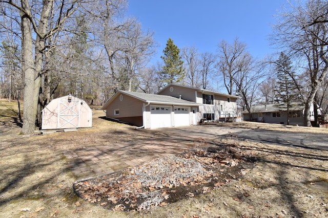 18045 Delaware Ln, Eden Lake Twp, MN 56362 - view of side of property featuring a garage, a storage shed, driveway, and an outbuilding