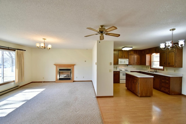 18045 Delaware Ln, Eden Lake Twp, MN 56362 - kitchen with white appliances, a chandelier, light countertops, a kitchen island, and a textured ceiling
