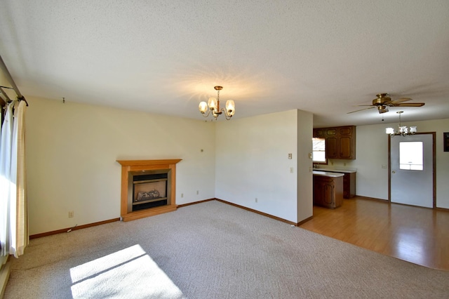 18045 Delaware Ln, Eden Lake Twp, MN 56362 - unfurnished living room featuring a chandelier, light colored carpet, a fireplace with raised hearth, baseboards, and a textured ceiling