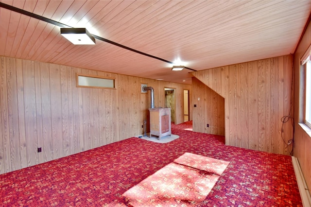 18045 Delaware Ln, Eden Lake Twp, MN 56362 - bonus room featuring a wood stove, carpet, a baseboard heating unit, wooden ceiling, and wooden walls