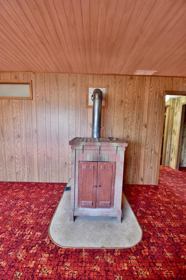 18045 Delaware Ln, Eden Lake Twp, MN 56362 - detailed view of wooden ceiling, carpet, wood walls, and a wood stove