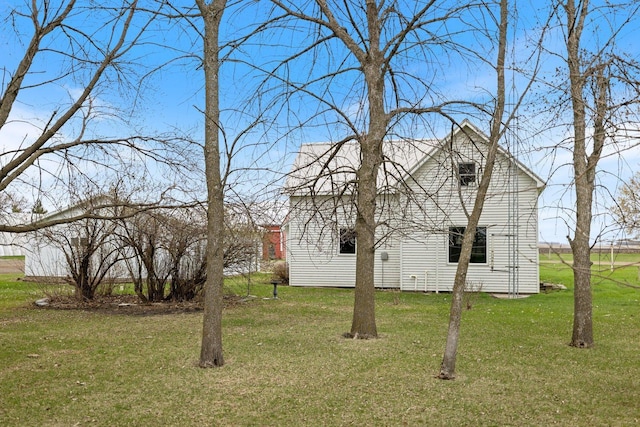 view of side of property featuring a yard