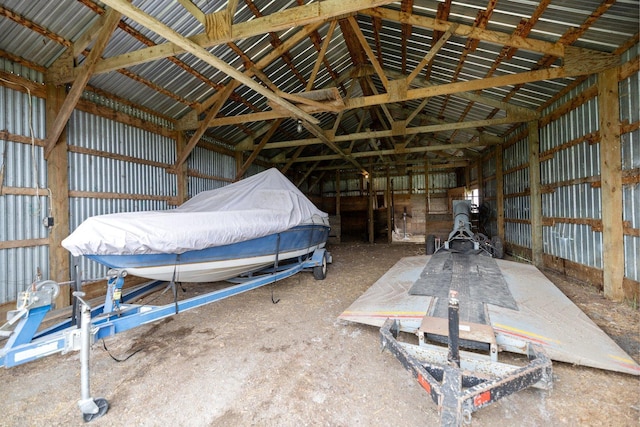 misc room featuring vaulted ceiling and metal wall